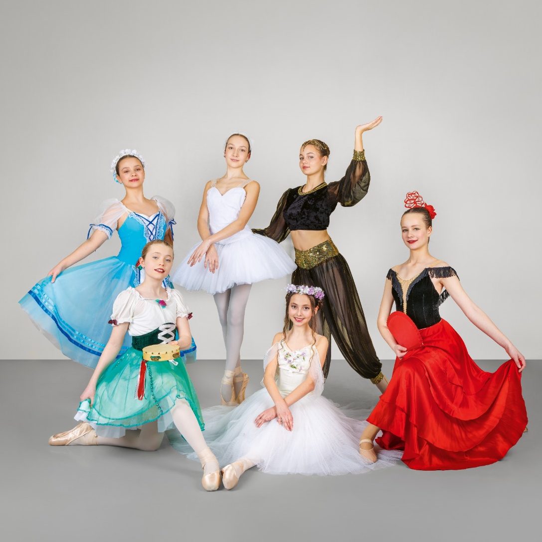 3 Kinder warten im Kostüm vor dem Auftritt im Backstage und wirken konzentriert.